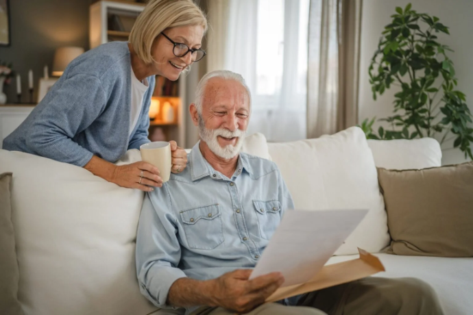 Indoor couple reviewing their savings.